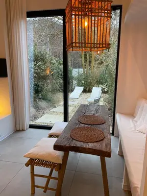 a dining room with a table and a chandelier at Oscarsleeps in Ghent