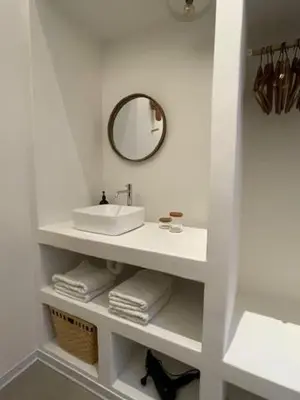 a white bathroom with a sink and a mirror at Oscarsleeps in Ghent