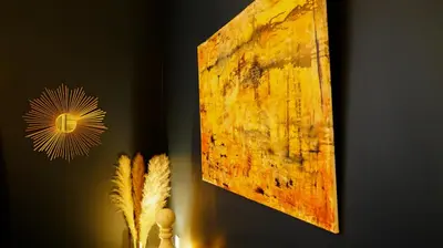 a wooden picture hanging on a wall next to a feather at Maison d'hôtes de Xavier in Brussels
