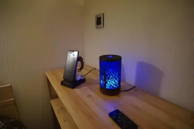 a cup sitting on a wooden table next to a charger at BrusselsHomes in Brussels
