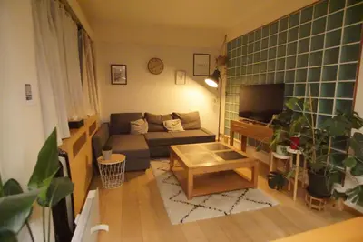 a small living room with a couch and a tv at BrusselsHomes in Brussels