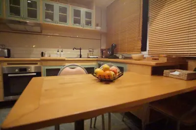 a kitchen with a bowl of fruit on a table at BrusselsHomes in Brussels