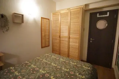 a bedroom with a bed and a window and a door at BrusselsHomes in Brussels