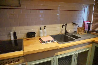a kitchen with a sink and a counter top at BrusselsHomes in Brussels