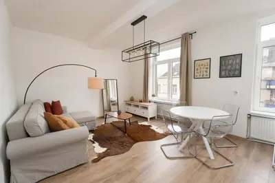 a living room with a couch and a table at Cozy apartement in the heart of Brussels in Brussels