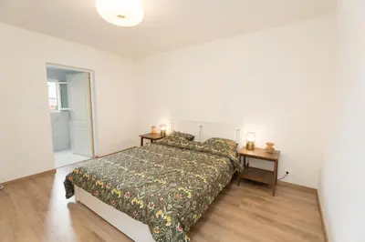 a bedroom with a bed and two night stands at Cozy apartement in the heart of Brussels in Brussels