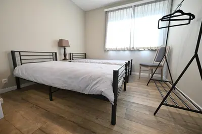 a bedroom with a bed and a large window at Luxe accomodatie d'einde in Beerse
