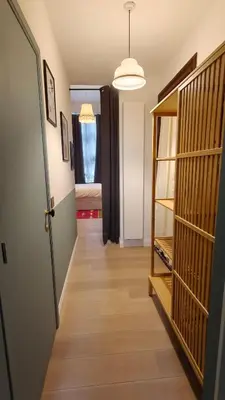 a hallway with a door and a room with a bedroom at Marilou and Dalibor's room in Brussels