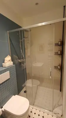 a bathroom with a shower with a toilet and a sink at Marilou and Dalibor's room in Brussels