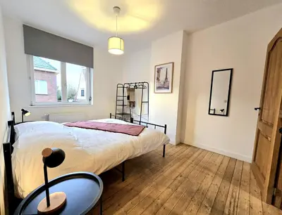 a bedroom with a large bed and a window at Noah's Atomium Appartments in Brussels