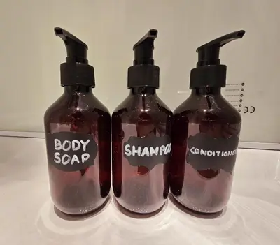 three bottles of soap sitting on top of a table at Noah's Atomium Appartments in Brussels