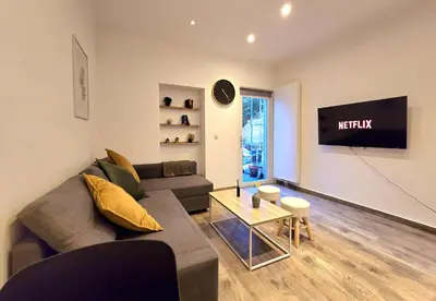 a living room with a couch and a table at Noah's Atomium Appartments in Brussels