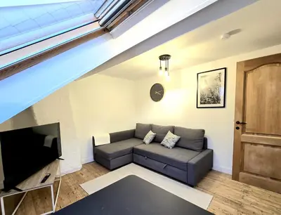 a living room with a couch and a tv at Noah's Atomium Appartments in Brussels