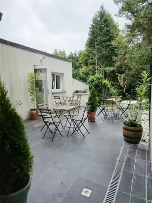 a patio with chairs and a table and trees at Noah's Atomium Appartments in Brussels