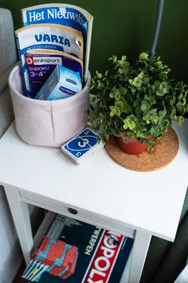 a white table with a plant and a box of toothpaste at Charming 18th Century Gem in the Heart of Old Town in Antwerp
