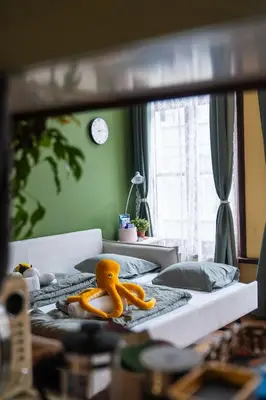 a mirror reflection of a bed with a yellow toy on it at Charming 18th Century Gem in the Heart of Old Town in Antwerp