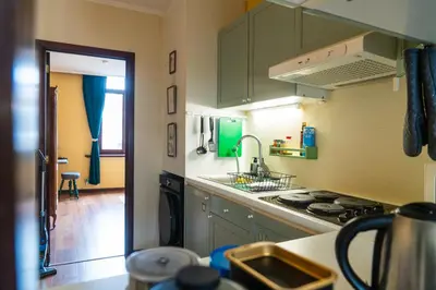 a kitchen with green cabinets and a stove top oven at Charming 18th Century Gem in the Heart of Old Town in Antwerp
