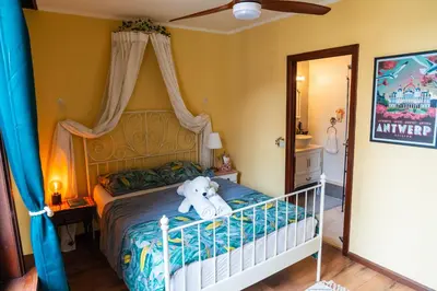 a teddy bear sitting on a bed in a room at Charming 18th Century Gem in the Heart of Old Town in Antwerp