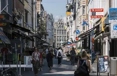 a group of people walking down a busy city street at Charming 18th Century Gem in the Heart of Old Town in Antwerp