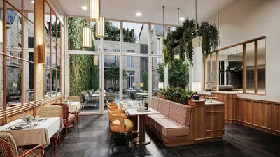 a restaurant with tables and chairs and large windows at Faubourg 21 in Brussels