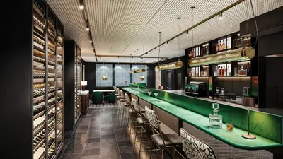 a bar with a green counter in a restaurant at Faubourg 21 in Brussels
