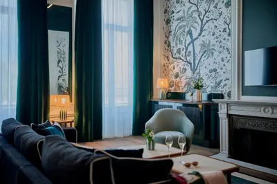 a living room with a couch and a fireplace at Faubourg 21 in Brussels