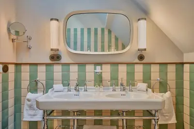 a bathroom with a sink and a mirror at Faubourg 21 in Brussels