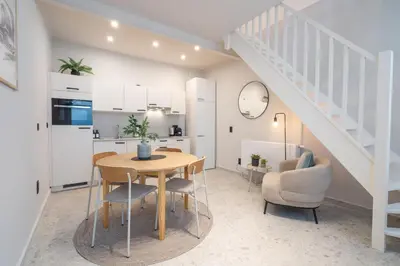 a kitchen and a dining room with a table and chairs at Gezellig, knusse en gerenoveerde rijwoning 4p in Ghent