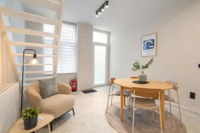 a living room with a table and a chair at Gezellig, knusse en gerenoveerde rijwoning 4p in Ghent
