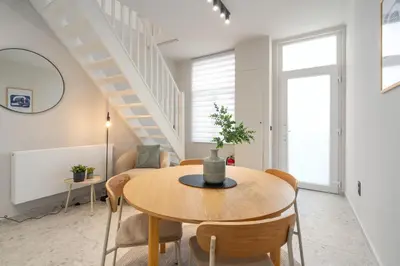 a dining room with a table and chairs at Gezellig, knusse en gerenoveerde rijwoning 4p in Ghent