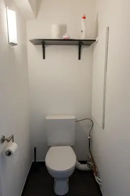 a small bathroom with a white toilet and a shelf at Jacuzzi & free parking at Andries Place in Antwerp