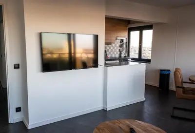 a kitchen with a white refrigerator in a room with windows at Jacuzzi & free parking at Andries Place in Antwerp