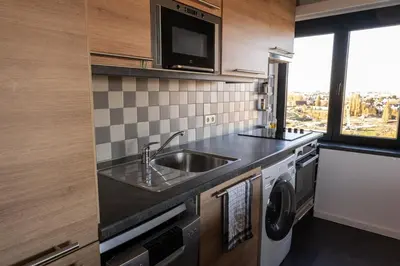 a kitchen with a sink and a microwave at Jacuzzi & free parking at Andries Place in Antwerp