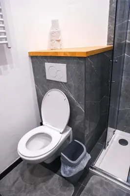 a bathroom with a white toilet and a sink at YabaMuandaz Apparts de Standing & Confort in Brussels