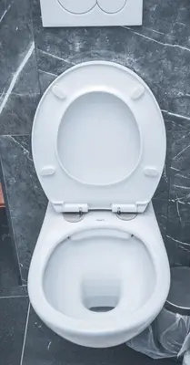a white toilet with the seat up in a bathroom at YabaMuandaz Apparts de Standing & Confort in Brussels