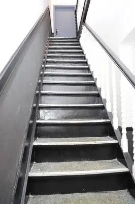 a metal staircase with a door in a building at YabaMuandaz Apparts de Standing & Confort in Brussels