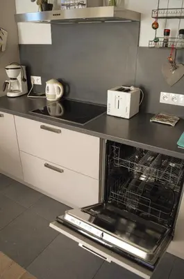 a kitchen with a stove top oven with a dishwasher at 1BR apt métro Hopital Erasme Bordet handicapt friendly in Brussels
