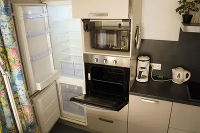a kitchen with an oven with a microwave at 1BR apt métro Hopital Erasme Bordet handicapt friendly in Brussels
