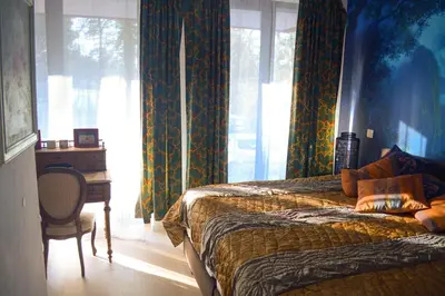 a bedroom with two beds and a desk and a window at 1BR apt métro Hopital Erasme Bordet handicapt friendly in Brussels