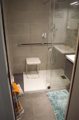 a shower with a glass door in a bathroom at 1BR apt métro Hopital Erasme Bordet handicapt friendly in Brussels