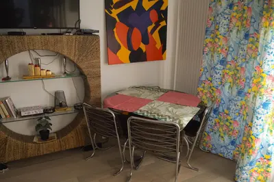 a table and chairs in a room with a painting at 1BR apt métro Hopital Erasme Bordet handicapt friendly in Brussels