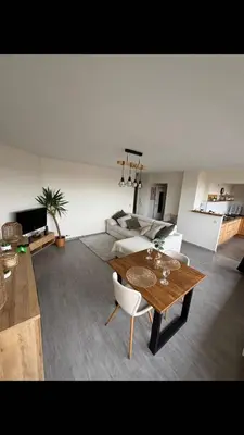 a living room with a table and a couch at Air Bey Penthouse in Brussels