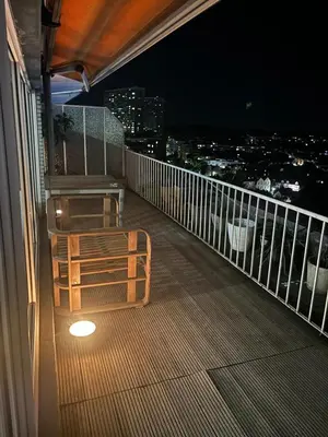a balcony at night with a bench on it at Air Bey Penthouse in Brussels