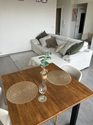 a living room with a wooden table and a couch at Air Bey Penthouse in Brussels