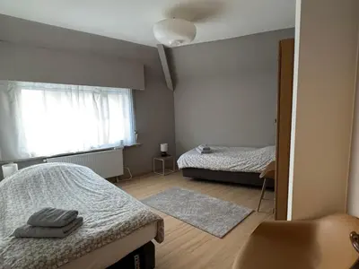 a small bedroom with two beds and a window at Centrally located house for six in Rumst
