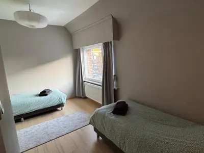 a bedroom with two beds and a window at Centrally located house for six in Rumst