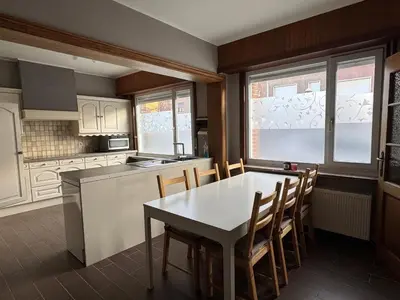 a kitchen with a white table and chairs and a table and a table at Centrally located house for six in Rumst