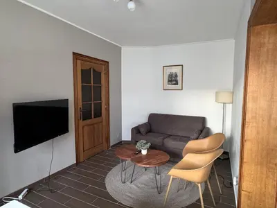 a living room with a couch and a table at Centrally located house for six in Rumst