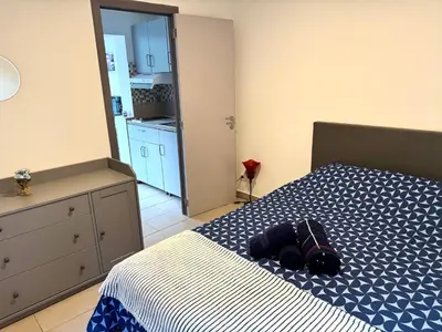 a bedroom with a bed with a backpack on it at Appartement cosy à Bruxelles métro Vandervelde in Brussels