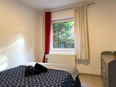 a bedroom with a bed and a window at Appartement cosy à Bruxelles métro Vandervelde in Brussels